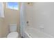 Bathroom featuring a toilet, bathtub with shower, and a window at 381 Rainbow Ln, Lafayette, CO 80026