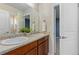 Bathroom featuring double sinks, a large mirror, and a doorway to the bedroom at 381 Rainbow Ln, Lafayette, CO 80026