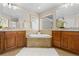 Luxurious bathroom with dual vanities, a soaking tub, and natural stone accents, offering a spa-like experience at 381 Rainbow Ln, Lafayette, CO 80026