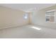 Large bedroom with neutral walls, carpet, and two windows for natural light at 381 Rainbow Ln, Lafayette, CO 80026