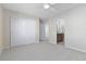 Neutral-toned bedroom with carpet, closet, and open doorway to the bathroom at 381 Rainbow Ln, Lafayette, CO 80026