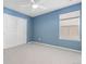 Blue bedroom featuring a ceiling fan, window with blinds, and a double-door closet at 381 Rainbow Ln, Lafayette, CO 80026
