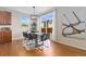 Bright dining area with modern lighting, a dining table with a view to the outdoor patio at 381 Rainbow Ln, Lafayette, CO 80026