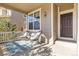 Inviting covered front porch featuring modern chairs and a stylish outdoor rug at 381 Rainbow Ln, Lafayette, CO 80026