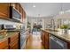 Well-appointed kitchen with stainless steel appliances, granite countertops, and view to dining area at 381 Rainbow Ln, Lafayette, CO 80026