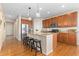 Spacious kitchen with a granite island, wooden cabinetry, stainless steel appliances and pendant lighting at 381 Rainbow Ln, Lafayette, CO 80026