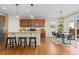 Bright kitchen featuring a large island, wooden cabinets, modern lighting, and an adjacent dining area at 381 Rainbow Ln, Lafayette, CO 80026