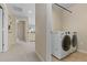 Laundry room with washer and dryer, conveniently located near the hallway at 381 Rainbow Ln, Lafayette, CO 80026
