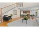 Spacious living room with stairs, hardwood floors and view to the kitchen and dining area at 381 Rainbow Ln, Lafayette, CO 80026