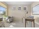 Bright home office with neutral walls, three windows, and comfortable seating, perfect for a productive work environment at 381 Rainbow Ln, Lafayette, CO 80026