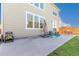 Large concrete patio features outdoor seating, a shade umbrella, and access to the backyard lawn at 381 Rainbow Ln, Lafayette, CO 80026