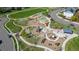 Aerial view of a modern community playground featuring diverse play structures and walking paths at 381 Rainbow Ln, Lafayette, CO 80026