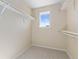 Bright walk-in closet with ample shelving and a window providing natural light at 381 Rainbow Ln, Lafayette, CO 80026