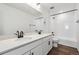 Bathroom featuring a double vanity with stone counters and a shower-tub at 9237 Truckee Ct, Commerce City, CO 80022