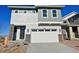 Two story home featuring mixed siding, a two car garage, and modern architectural details at 9237 Truckee Ct, Commerce City, CO 80022