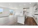 Modern, open concept kitchen with an island and stainless steel appliances at 9237 Truckee Ct, Commerce City, CO 80022