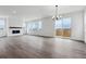 Living room with large windows, a fireplace, and plenty of natural light at 9237 Truckee Ct, Commerce City, CO 80022