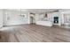 Open concept living room with kitchen and stainless steel appliances at 9237 Truckee Ct, Commerce City, CO 80022