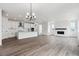 Open concept living room with a fireplace and kitchen at 9237 Truckee Ct, Commerce City, CO 80022