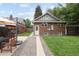 The rear exterior features brick, a grassy lawn, privacy fence and a patio, perfect for relaxation and outdoor activities at 3039 W Denver Pl, Denver, CO 80211