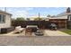 This expansive backyard patio has a grill, lounge seating, an umbrella, and a gravel area for relaxing and outdoor entertaining at 3039 W Denver Pl, Denver, CO 80211