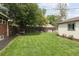 The well maintained backyard is fully fenced and offers a mature, plush lawn, swing, and accessory building at 3039 W Denver Pl, Denver, CO 80211