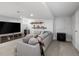 Spacious finished basement with cozy seating, TV, and modern shelving at 3039 W Denver Pl, Denver, CO 80211