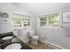 Bright bathroom with dual sinks, toilet and multiple windows at 3039 W Denver Pl, Denver, CO 80211