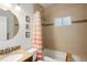 Well-lit bathroom featuring a tiled shower and bathtub combination at 3039 W Denver Pl, Denver, CO 80211