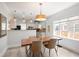 Open dining area with modern lighting fixtures and a clear view of the kitchen at 3039 W Denver Pl, Denver, CO 80211