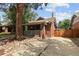Cozy brick home with a covered porch, chimney, and concrete driveway with side yard access at 3039 W Denver Pl, Denver, CO 80211