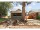 Quaint brick home with a covered porch, rock garden, and mature tree in front at 3039 W Denver Pl, Denver, CO 80211