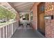 Inviting front porch with seating area, a brick exterior, and a 'No Soliciting' sign at 3039 W Denver Pl, Denver, CO 80211