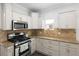 Bright kitchen featuring stone backsplash, stainless steel appliances and ample cabinet space at 3039 W Denver Pl, Denver, CO 80211