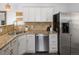 Kitchen featuring granite countertops, stainless steel appliances, and white cabinetry at 3039 W Denver Pl, Denver, CO 80211
