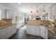 Bright kitchen featuring stone backsplash, stainless steel sink, and granite countertops at 3039 W Denver Pl, Denver, CO 80211