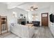 Open living area with a fireplace, ceiling fan, and a decorative ladder at 3039 W Denver Pl, Denver, CO 80211