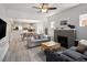 Bright living room featuring hardwood floors, a fireplace, and an open layout at 3039 W Denver Pl, Denver, CO 80211