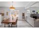 Open-concept living and dining area filled with natural light and modern decor at 3039 W Denver Pl, Denver, CO 80211