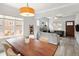 Spacious open-concept room with dining area, hardwood floors, and a modern fireplace at 3039 W Denver Pl, Denver, CO 80211