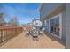 Inviting back deck features wood flooring, outdoor dining set and slider door for seamless indoor/outdoor living at 5253 S Jericho St, Centennial, CO 80015