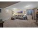 Basement den featuring a comfortable sectional couch, window, and neutral carpet at 5253 S Jericho St, Centennial, CO 80015