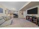 Spacious basement includes a lounge area and a desk area with a large television at 5253 S Jericho St, Centennial, CO 80015