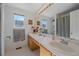 Bright bathroom showcasing a large vanity, ample counter space, and a shower at 5253 S Jericho St, Centennial, CO 80015