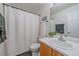 Cozy bathroom features a shower with white curtain, single vanity, and nautical decor at 5253 S Jericho St, Centennial, CO 80015