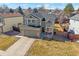 Well-maintained two-story home featuring a manicured lawn and inviting curb appeal at 5253 S Jericho St, Centennial, CO 80015