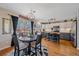 Stylish kitchen and dining area featuring a modern light fixture and deck access at 5253 S Jericho St, Centennial, CO 80015