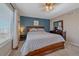 Inviting main bedroom with a blue accent wall, ceiling fan, and natural light at 5253 S Jericho St, Centennial, CO 80015