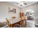 Cozy dining room features a vintage table and chairs, and an open arch to kitchen space at 547 S 3Rd Avenue, Brighton, CO 80601