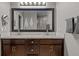 Bright bathroom with double vanity, granite countertops, framed mirror and subway tile backsplash at 15220 E Caley Ave, Centennial, CO 80016